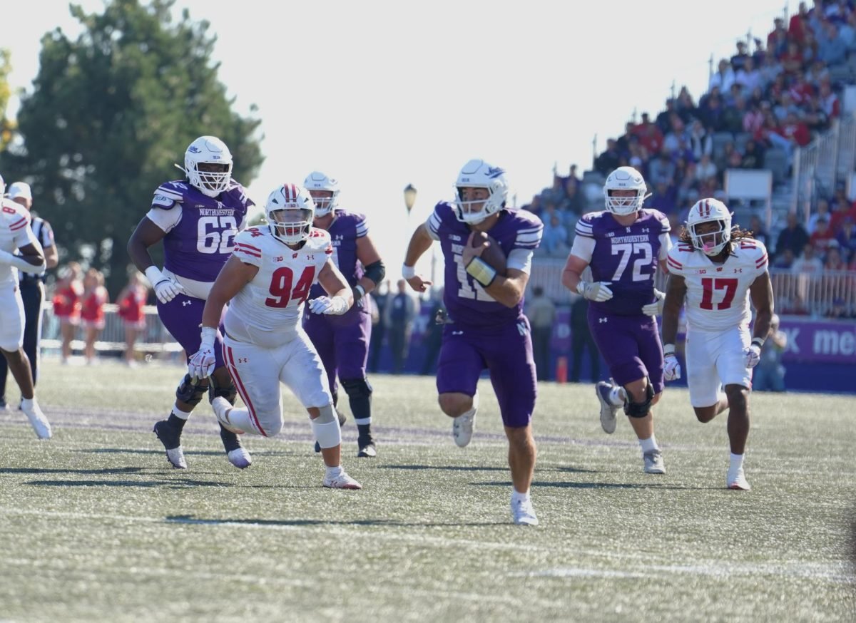 Redshirt sophomore quarterback Jack Lausch scrambles against Wisconsin Saturday.