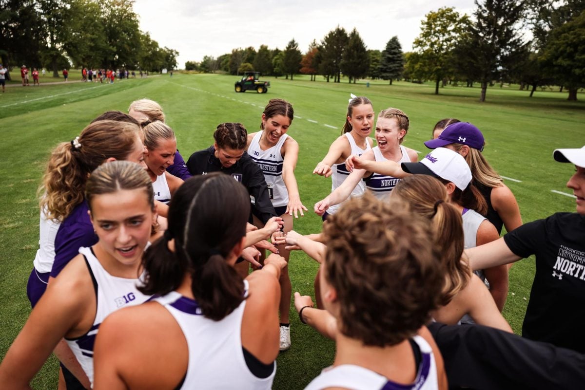 Northwestern huddles before a meet earlier this season.