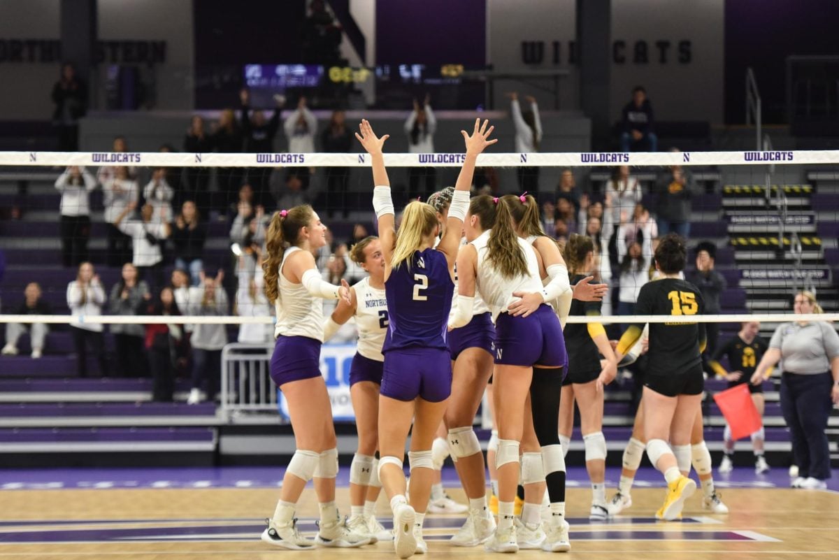 Volleyball players celebrate a point