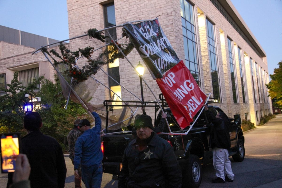 At around 6:25 p.m., a pickup track flanked by six University Police officers arrived at The Rock. 