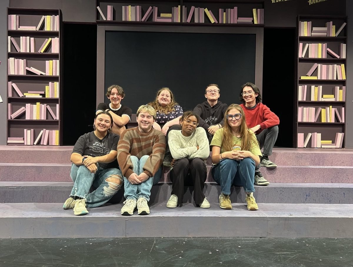 Students on the YAMO board pose in front of the set. 
