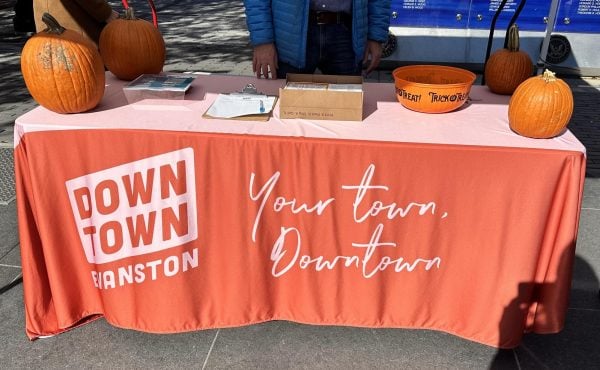 Downtown Evanston employees hand out Trick or Treat Stroll maps
