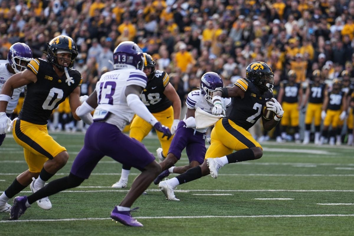 Iowa running back Kaleb Johnson evades tacklers during his team's victory over Northwestern Saturday.