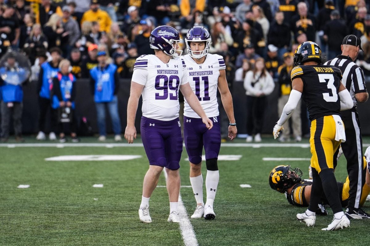 Redshirt junior punters Hunter Renner and Luke Akers walk off the field after an extra point attempt in the fourth quarter. 