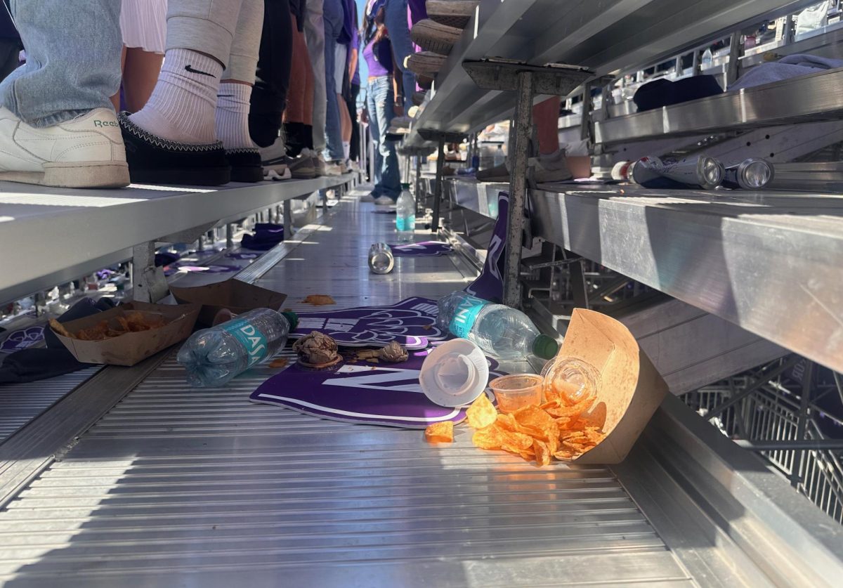 Non-compostable food vessels and other litter crowd the bleacher stands of Martin Stadium. 
