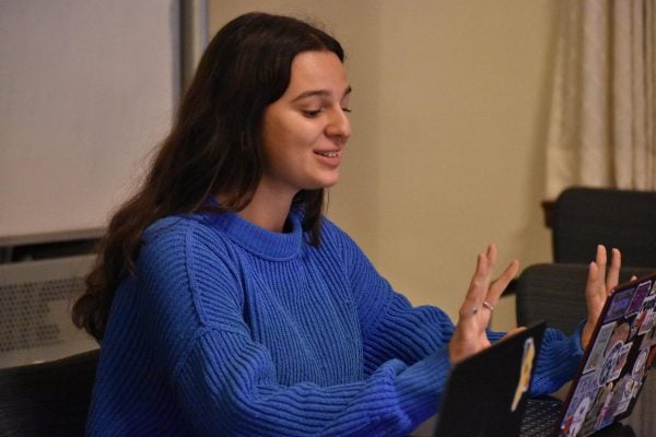 Person speaking in front of a computer.