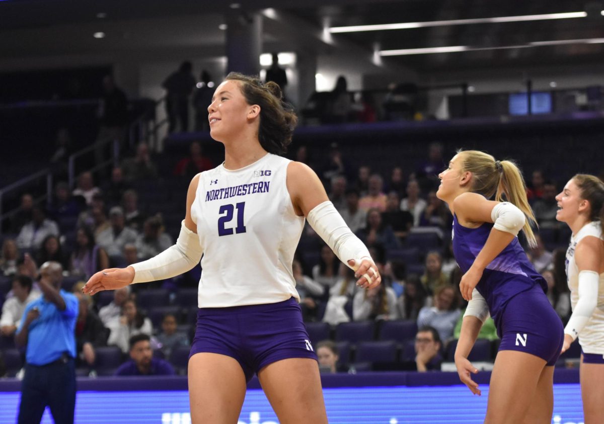 An athlete in a white jersey celebrates after scoring a point.