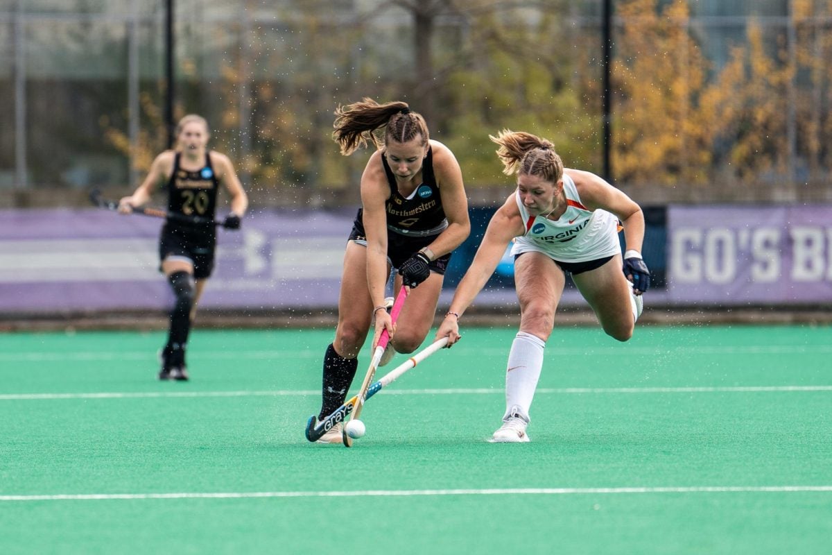 Senior midfielder Maddie Zimmer carries the ball against Virginia in NU's NCAA Tournament quarterfinal match.