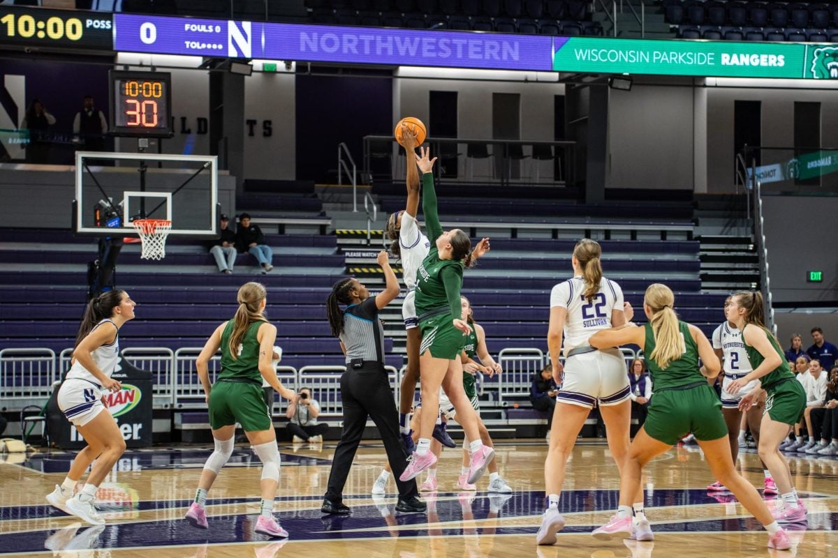 Graduate student forward Taylor Williams jumps for the tip-off during her first game as a Wildcat.