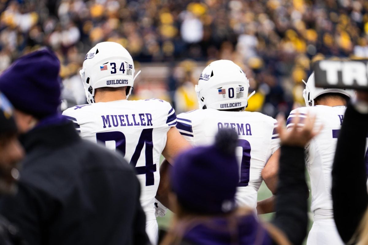 Graduate student linebacker Xander Mueller and graduate student safety Coco Azema walk out for the coin toss as captains ahead of Saturday’s game at Michigan.