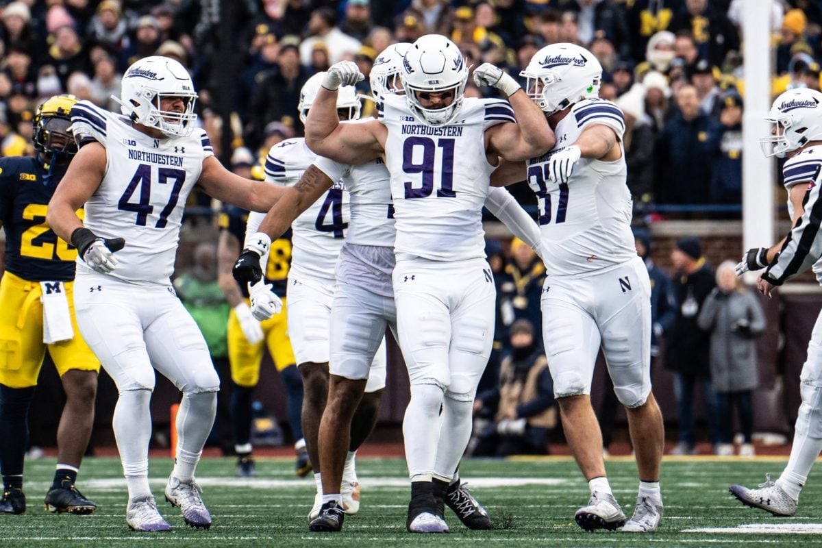 Redshirt junior defensive end Aidan Hubbard celebrates against Michigan.