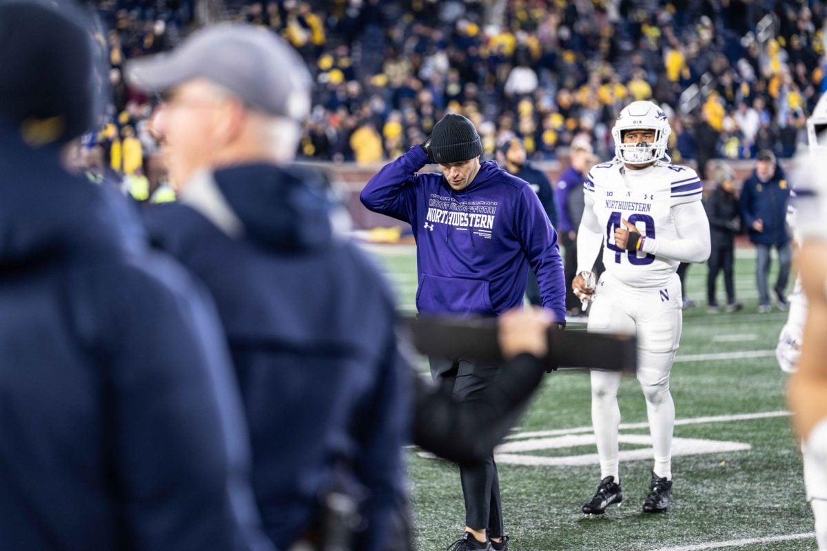 Coach David Braun walks off the field against Michigan on Nov. 23.