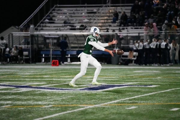 Northwestern commit Nikola Dugandzic punts the ball during a New Trier High School football game. 