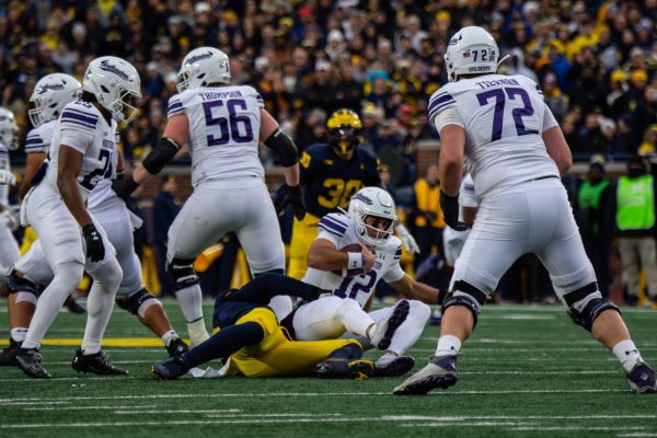 Redshirt sophomore quarterback Jack Lausch gets sacked during Northwestern's 50-6 loss to Michigan on Saturday. 