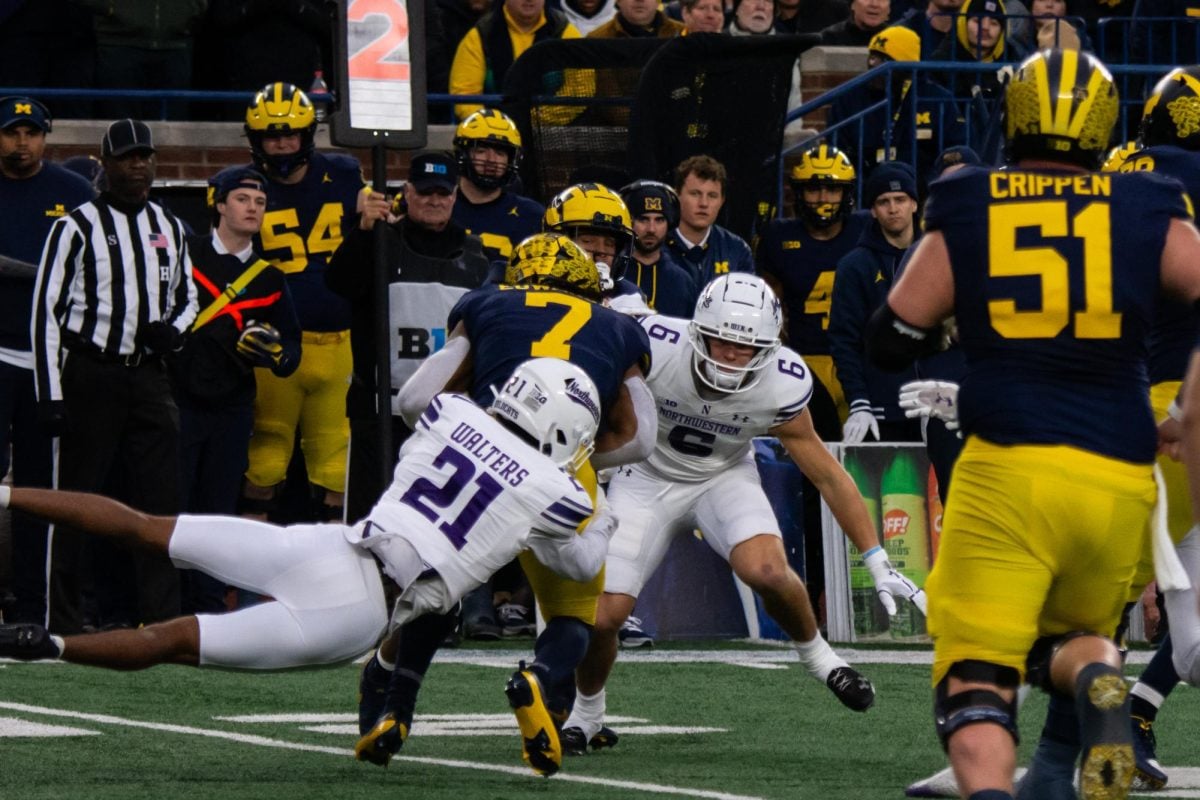 Redshirt freshman safety Damon Walters looks to make a tackle during Northwestern's 50-6 loss to Michigan on Saturday.