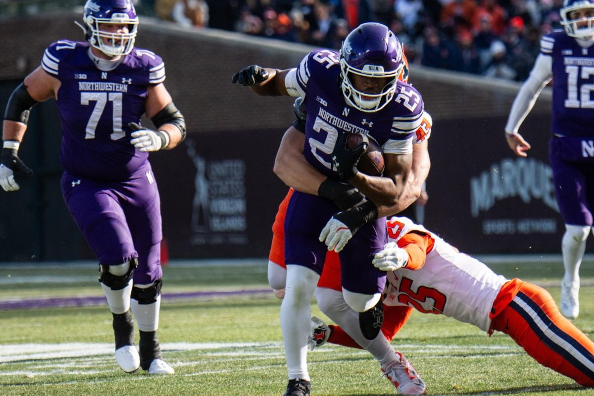 Redshirt freshman running back Caleb Komolafe rushes against No. 23 Illinois on Saturday.