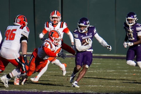 Graduate student wide receiver A.J. Henning eludes tacklers against Illinois on Saturday.