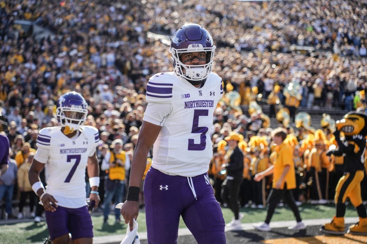 Graduate student quarterback Mike Wright runs onto the field ahead of Northwestern's game against Iowa on Oct. 26.