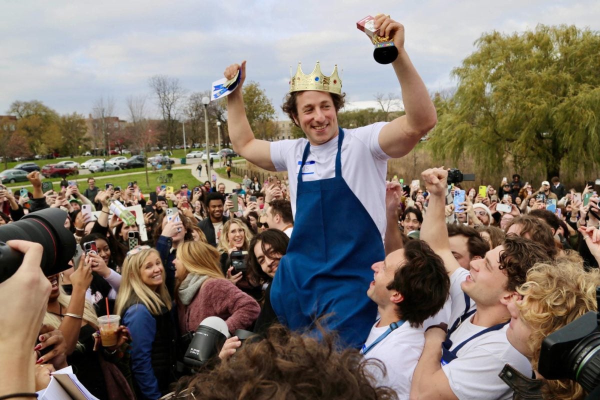 Man hoisted up in air by crowd.