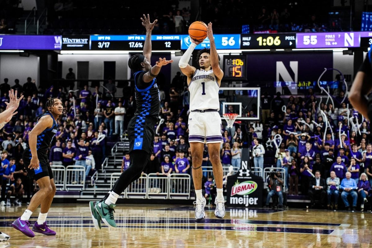 Graduate student guard Jalen Leach shoots his lead-taking three-pointer against Eastern Illinois Friday.