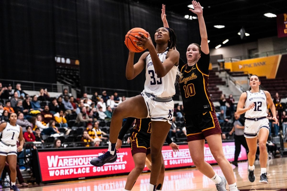 Graduate student forward Taylor Williams leaps to take a shot.