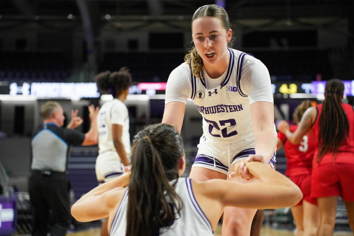 Junior forward Grace Sullivan helps up teammate sophomore guard Casey Harter against Illinois State on Wednesday.