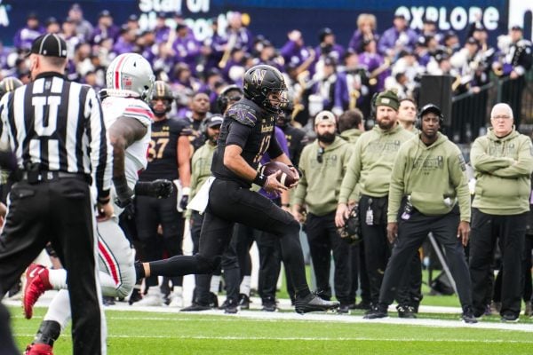 Redshirt sophomore quarterback Jack Lausch scrambles downfield against No. 2 Ohio State on Saturday. Lausch lost a red zone fumble on Northwestern's opening drive.