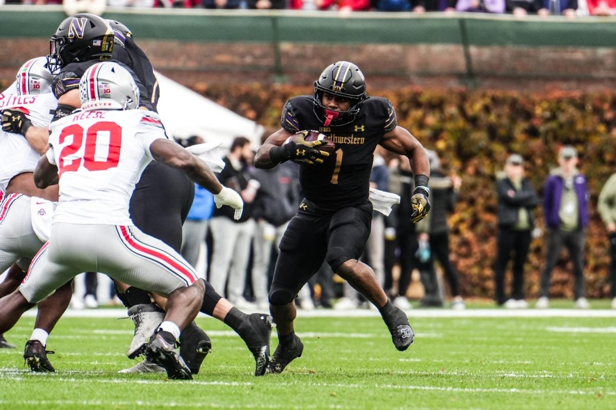 Graduate student running back Cam Porter rushes against Ohio State on Nov. 16. Porter has amassed 594 scrimmage yards and six touchdowns this season.