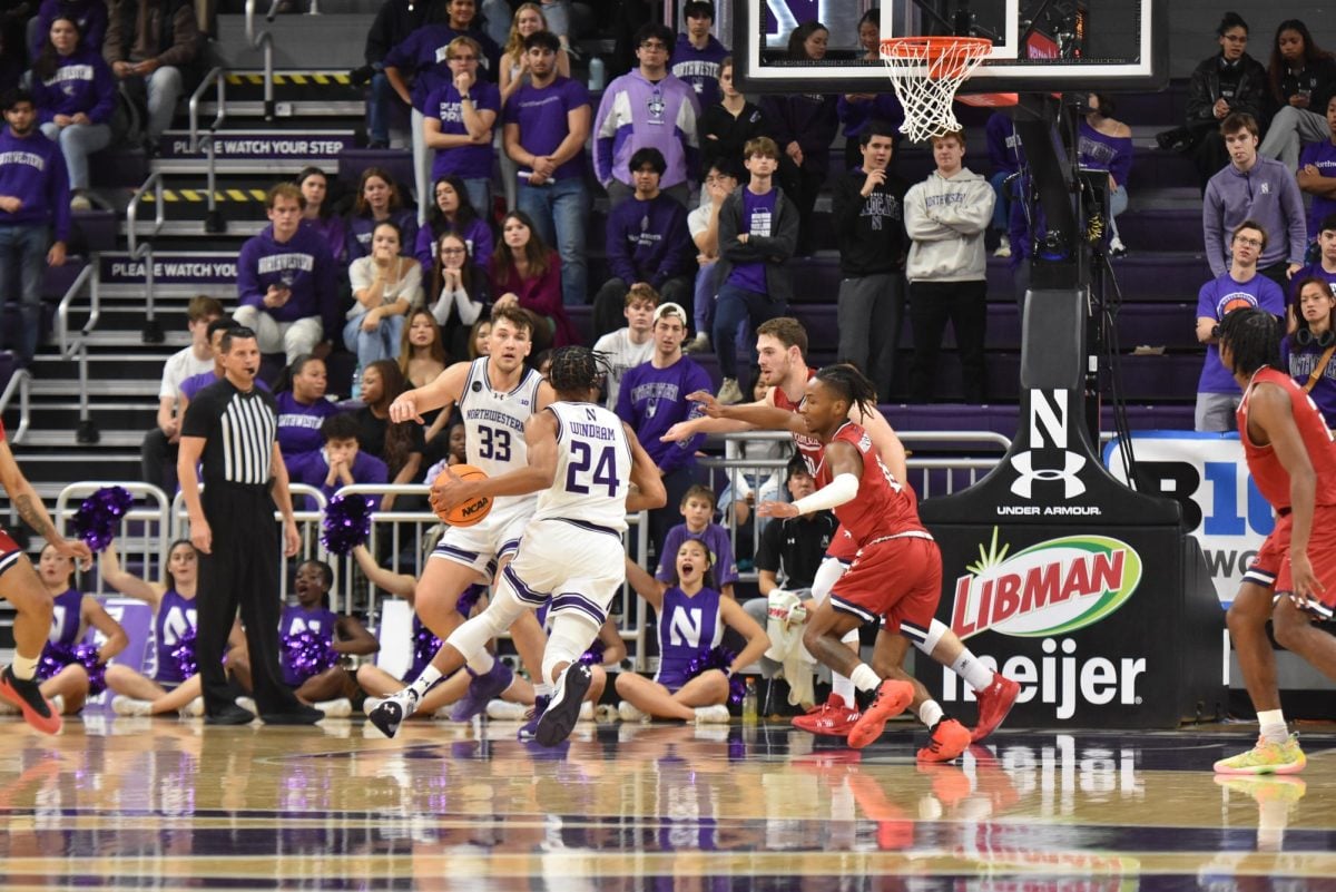 K.J. Windham dribbles around a defender.