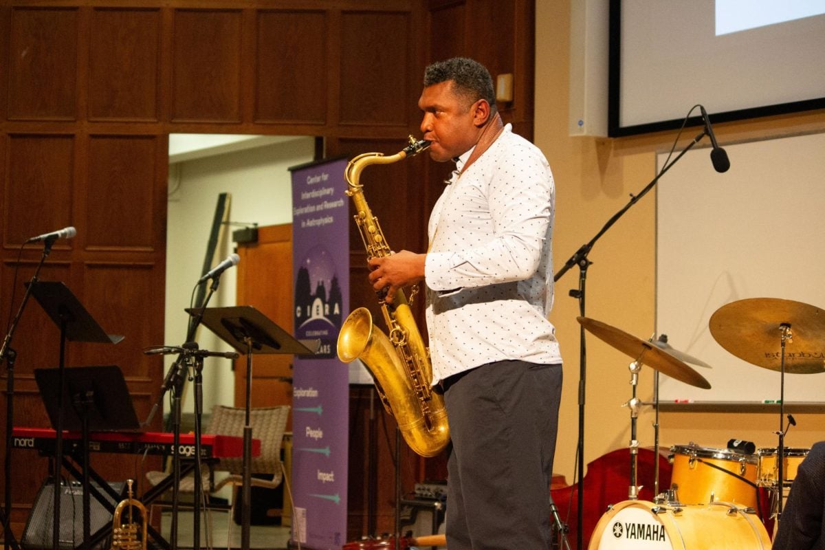 Alexander demonstrates a musical idea on his saxophone. 
