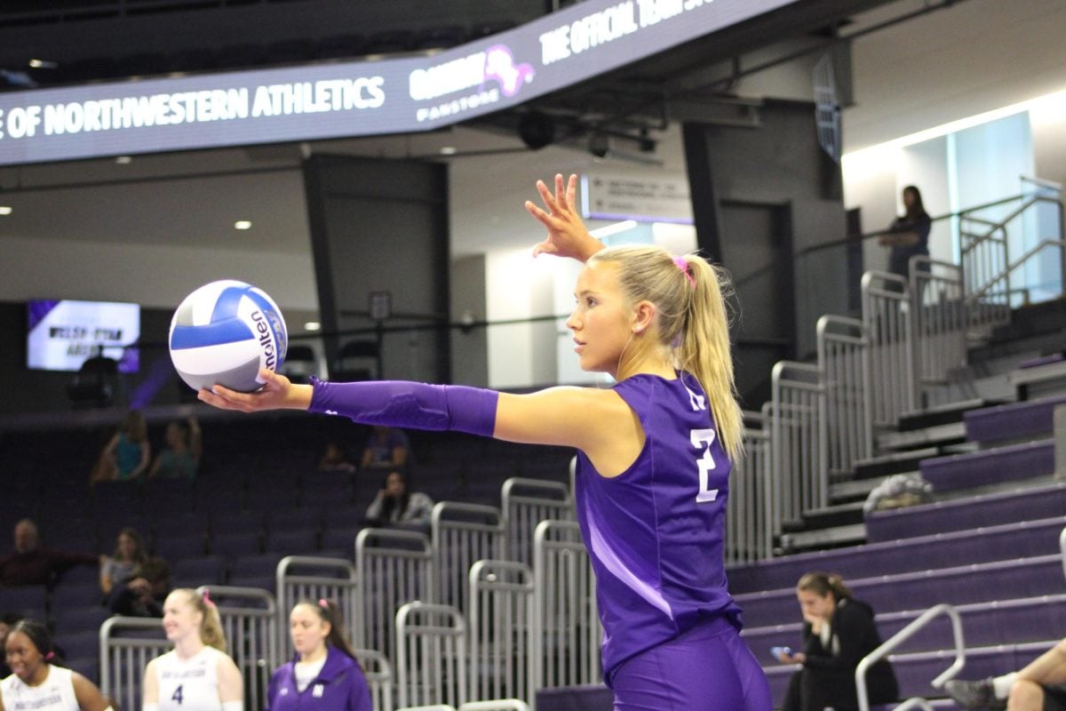 Sophomore libero Drew Wright prepares to serve in a match earlier this season.