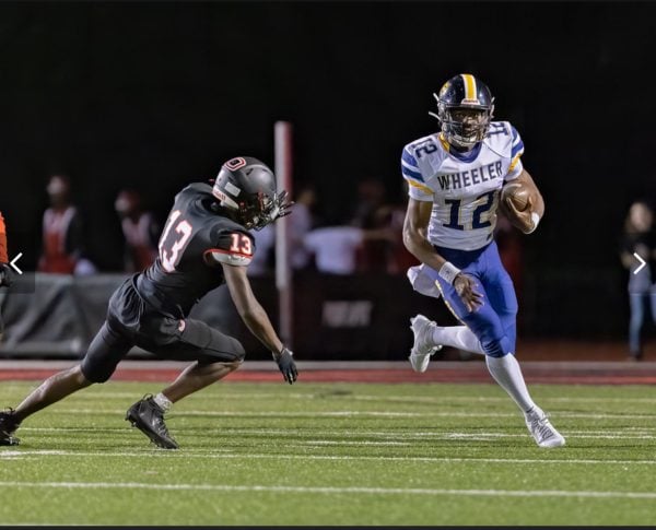 Northwestern 2025 quarterback commit Marcus Romain makes a play at quarterback for Wheeler High School. He will begin training with the Wildcats in January as an early enrollee.