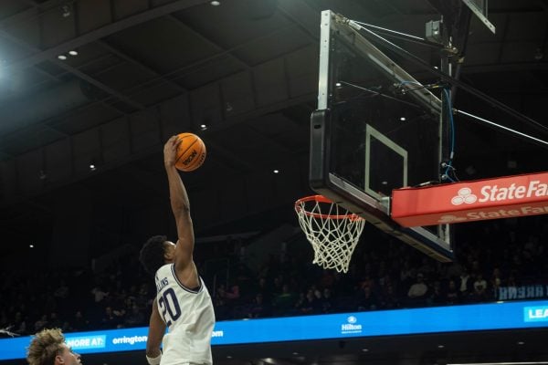 Junior guard Justin Mullins slams home a fast break dunk.