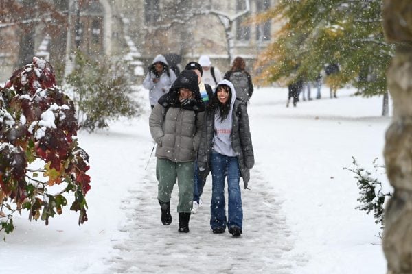 People savor Northwestern’s first snowfall of the season near University Hall on Thursday.