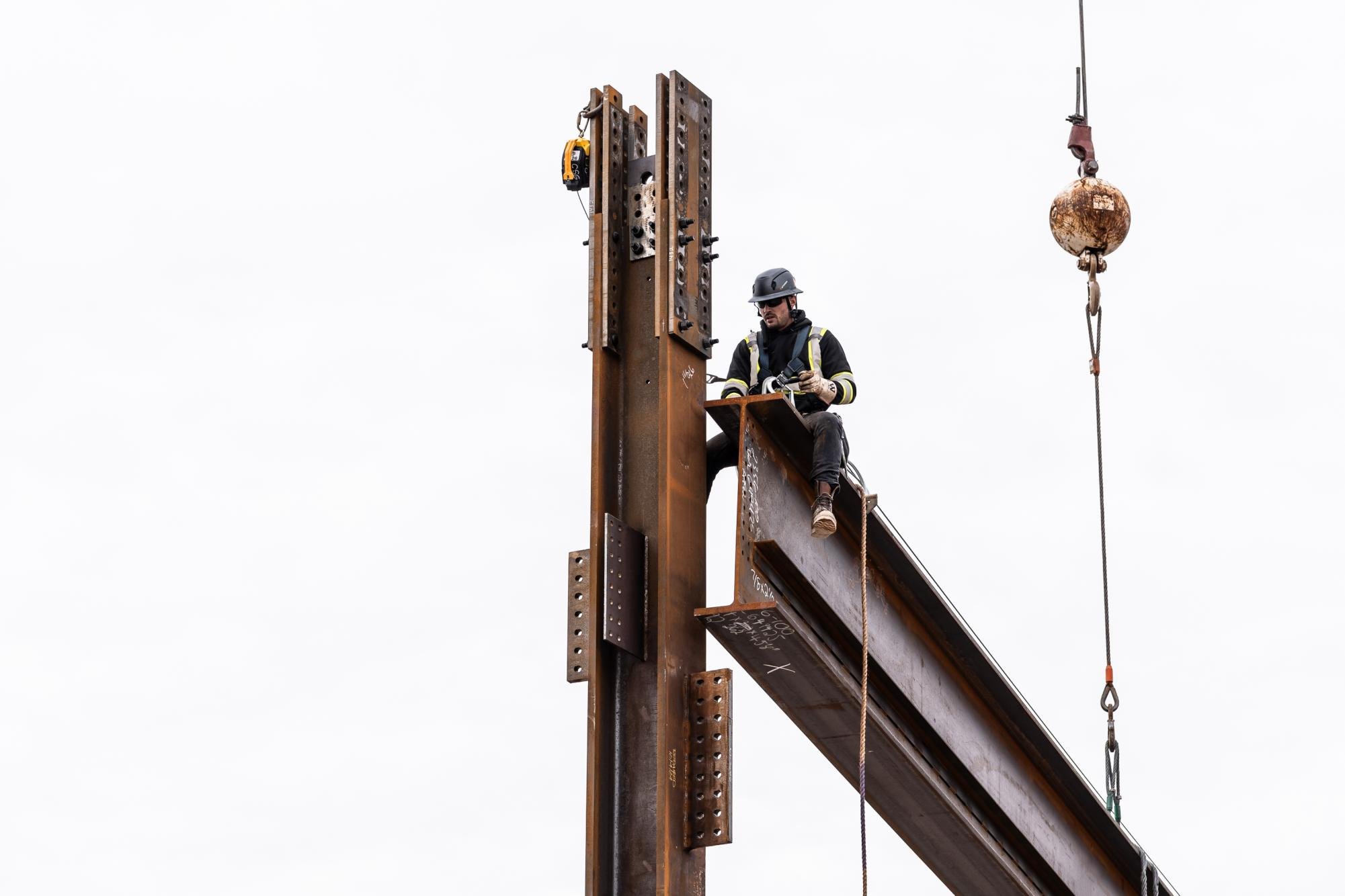 A worker attaches a header to a steel beam on the construction site of the new Ryan Field Wednesday.