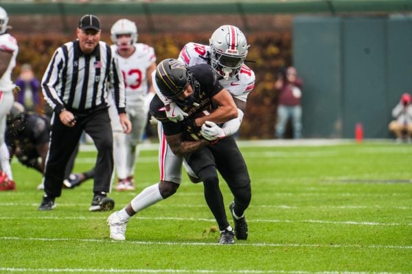 Graduate student wide receiver Bryce Kirtz fights for extra yardage against No. 2 Ohio State on Saturday.