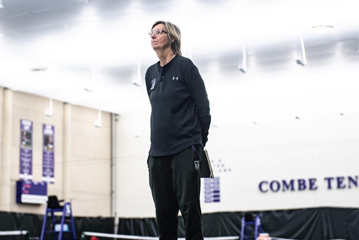 Northwestern coach Claire Pollard stands for the national anthem for a match last season. She’s in her 26th season as the Wildcats’ head coach.