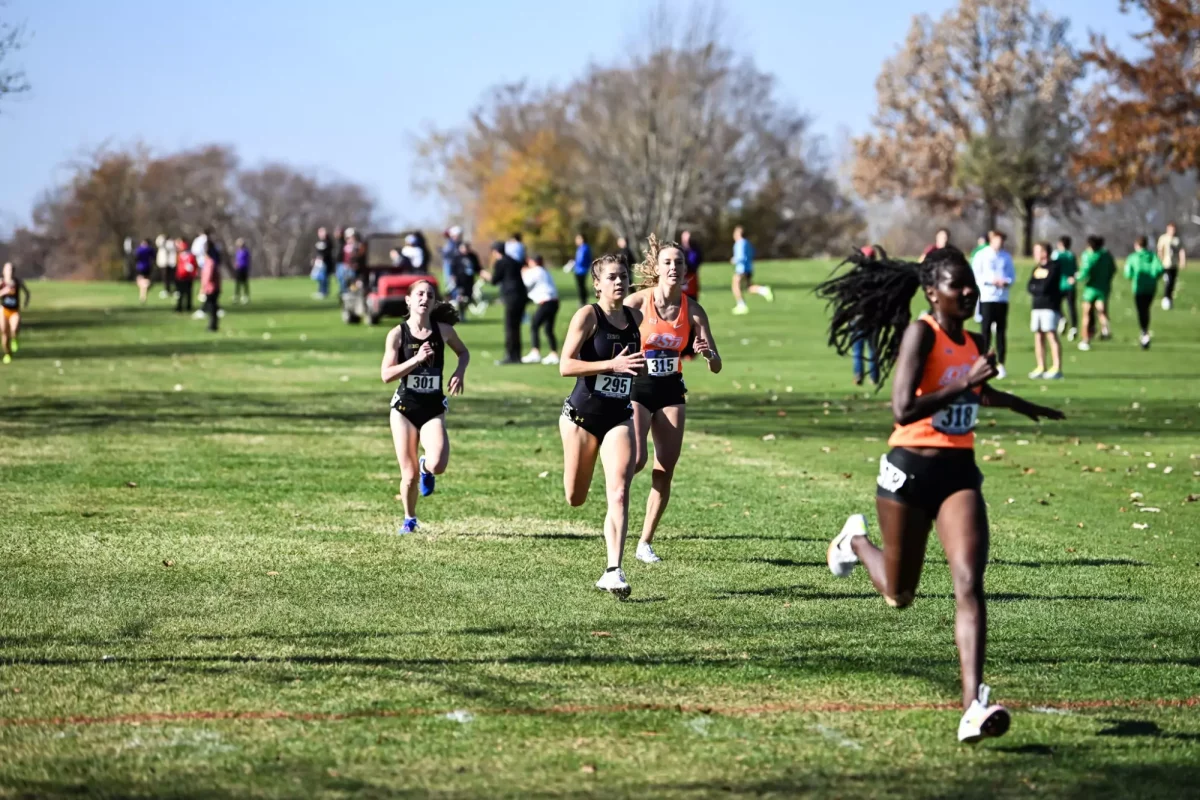  Senior Ava Earl runs in the NCAA Midwest Regional in Peoria Friday with graduate student Chloe Wellings trailing just behind. 