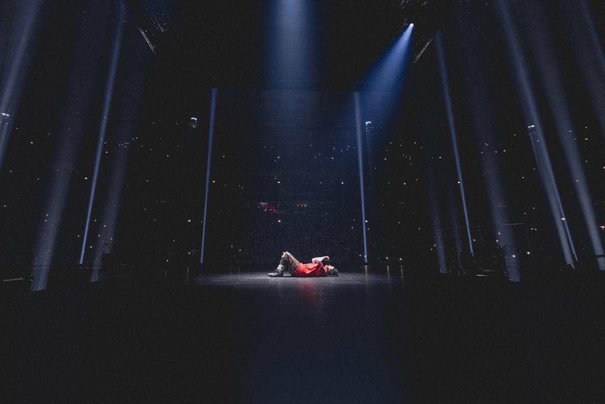 Billie Eilish lies down as she sings “when the party’s over” during Wednesday night’s performance at the United Center.