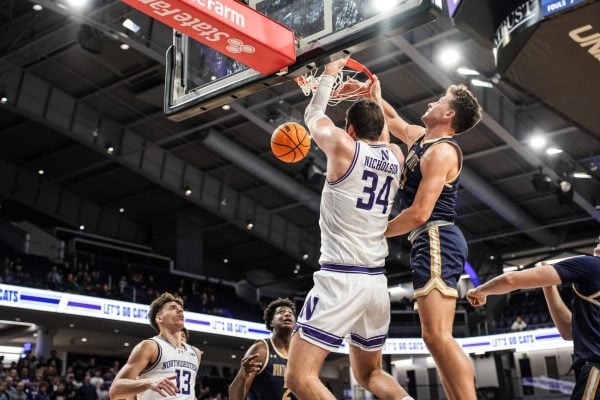 Graduate student center Matthew Nicholson slams home a lead-taking alley oop against Montana State Tuesday,