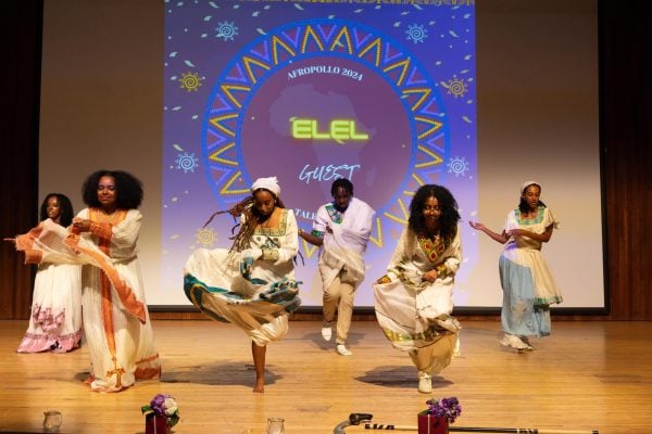 Dancers perform on a stage.