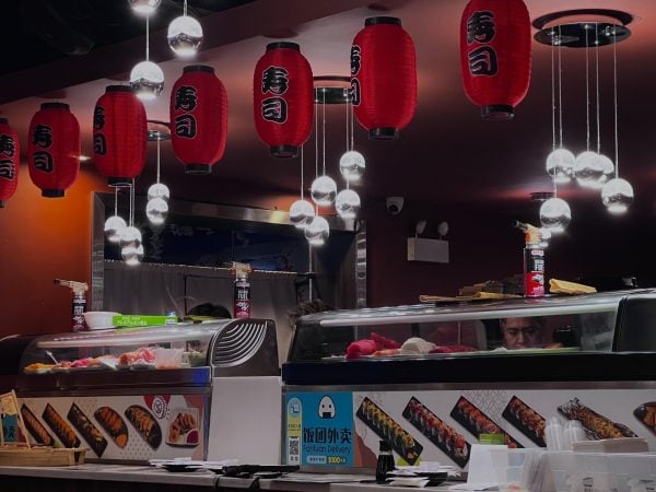 Traditional lanterns hang over the sushi bar at Mira Sushi’s Chinatown location.
