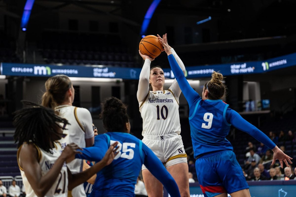 Senior forward Caileigh Walsh shoots the ball against DePaul Wednesday. Walsh earned her 1,000th career point in the win.