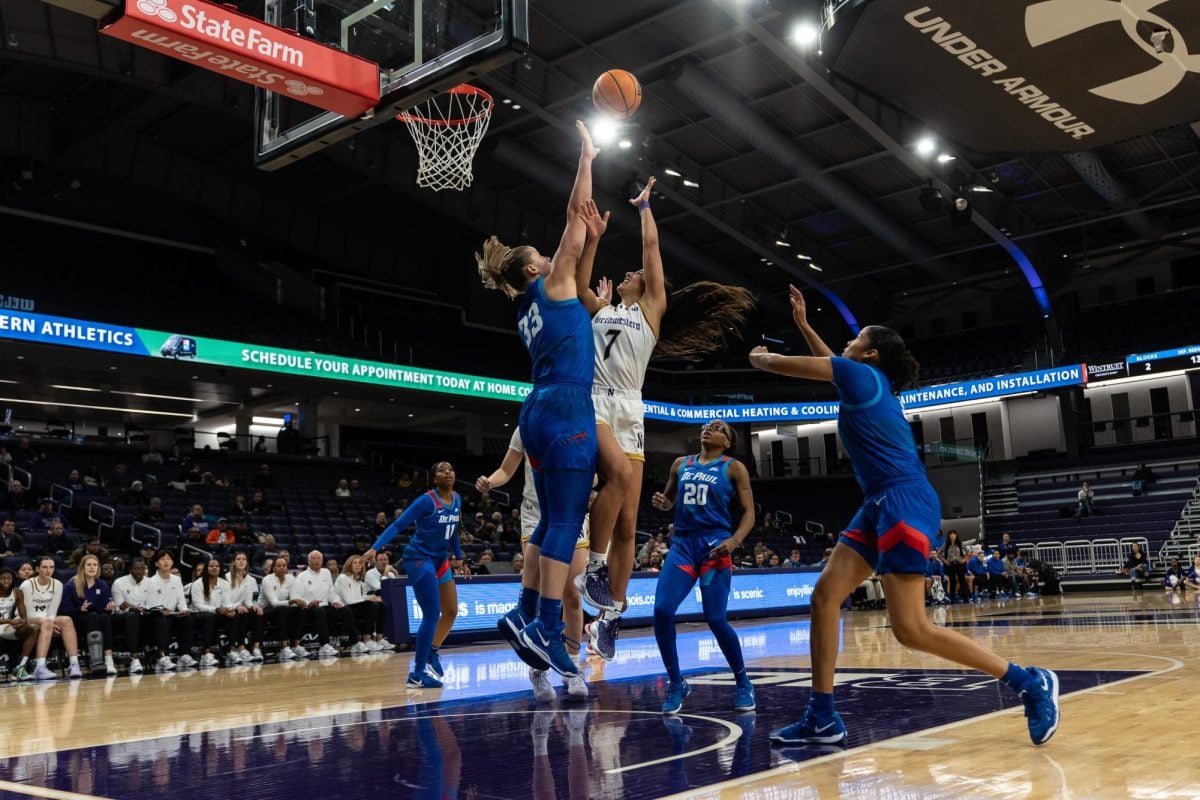 Junior guard Caroline Lau tries a shot against DePaul last week. Lau finished with nine points, five rebounds and seven assists Sunday. 