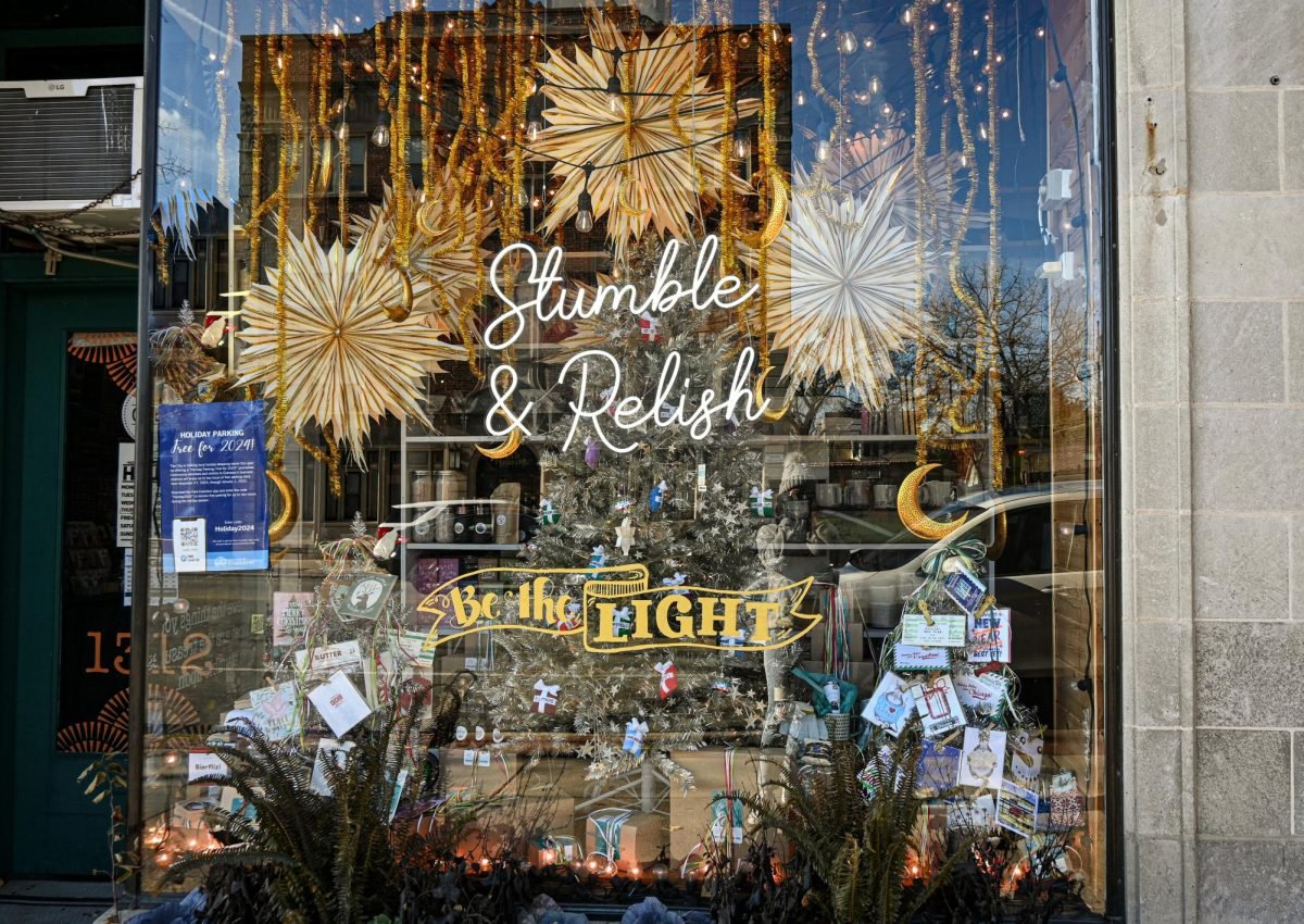 Stumble &amp; Relish’s window display glitters with gold and silver decorations.