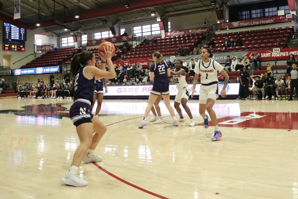 Sophomore guard Casey Harter passes the ball in Northwestern’s 68-66 win over Howard Saturday.