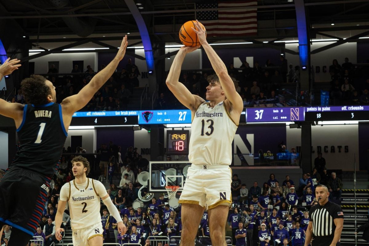 Senior guard Brooks Barnhizer attempts a midrange shot over a DePaul defender. Barnhizer notched his fifth straight double-double Saturday. 