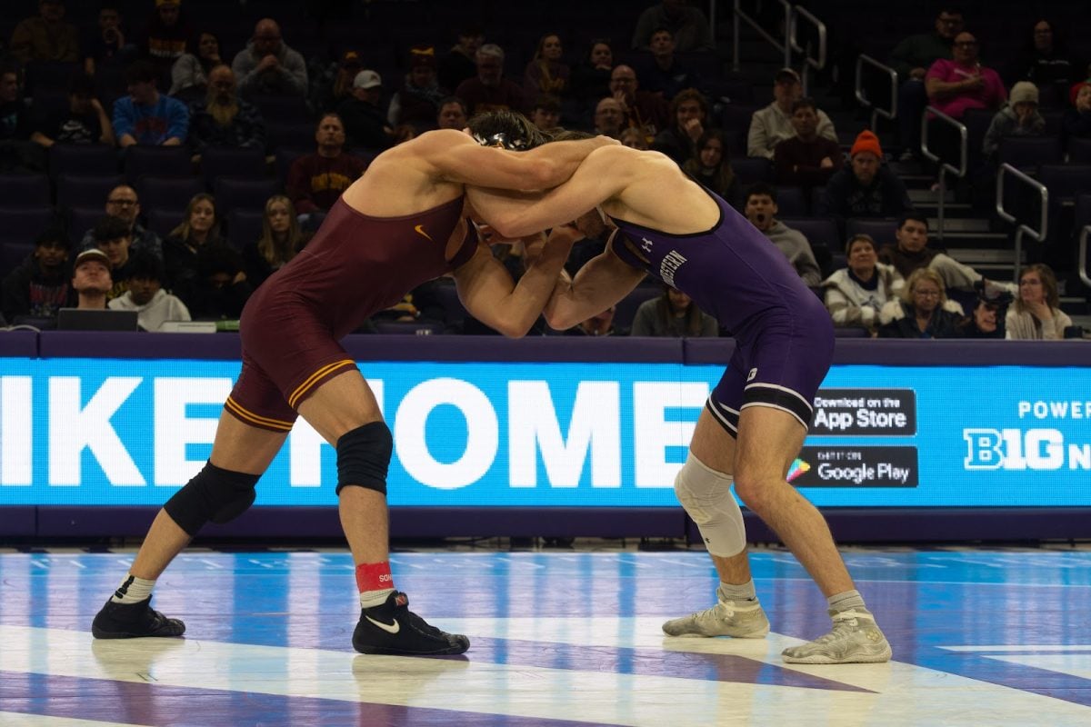 No. 9 graduate student 157-pounder Trevor Chumbley engages in head hands defense against Minnesota’s No. 8 Tommy Askey.