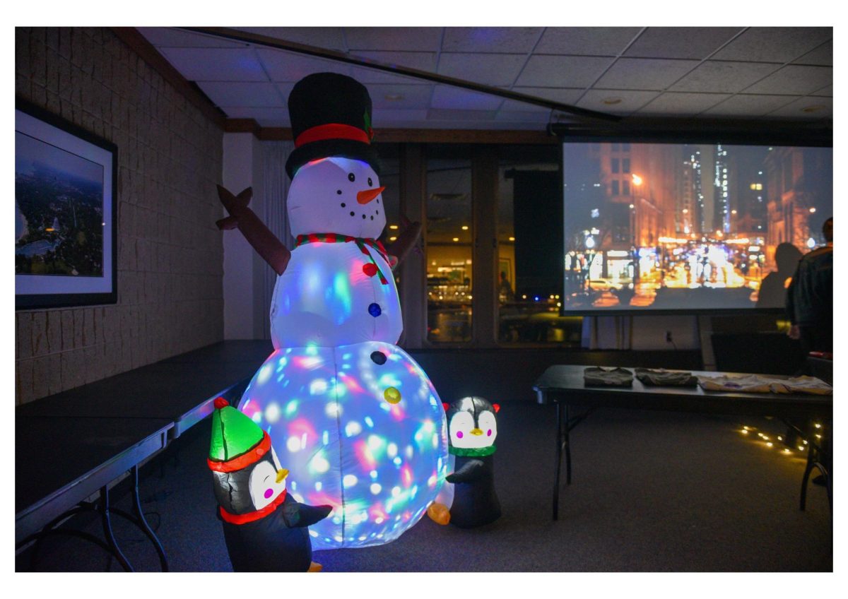 An inflatable snowman — and its pet penguins — light up a room with festive cheer.