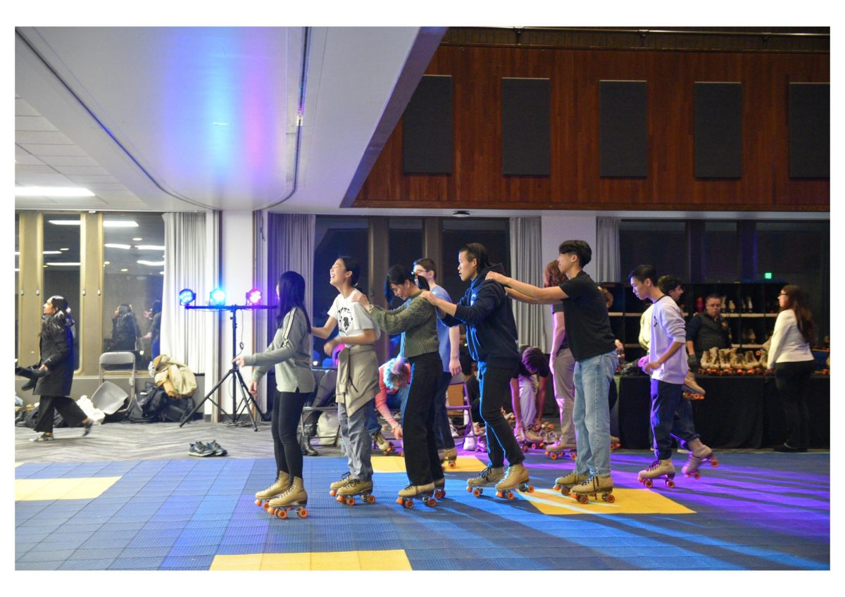 WinterFest attendees form a conga line as they roller skate across the Louis room.